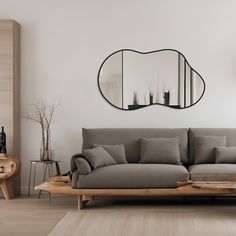 a living room with a couch and mirror on the wall