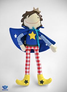 a stuffed toy with a cape and stars on it's chest, standing upright