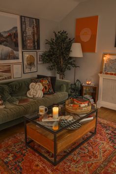 a living room with a couch, coffee table and pictures on the wall above it