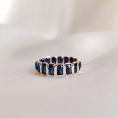 This stunning ring is set in 14k Solid Yellow Gold with Natural Blue Sapphire with utmost precision. It is an unique dainty gemstone ring for nearly every occasion and is completely hassle-free jewelry. ITEM DETAILS * Gem: Blue Sapphire * Gem Size: 3x6mm (17pcs) * Gem Shape: Rectangle * Gem weight: 5.90 carats * Gold Purity: 14KT * Gold Weight: 1.35 gram * Total Weight of the Ring: 2.53 gram The Gold purity is guaranteed and it comes with authentic 14KT gold hallmark. Since my items are handmade, they are absolutely nickel and lead free. CUSTOMIZATION: * Size Customization is available for this ring and it is available in all ring sizes. Kindly choose your ideal ring size from the drop-down. * The ring is available in 14K as well 18K Solid Gold. Kindly choose your preferred gold purity fro Faceted Sapphire Ring In Fine Jewelry Style, Elegant Faceted Sapphire Promise Ring, Fine Jewelry Stackable Sapphire Jewelry, Blue Emerald Cut Stackable Jewelry, Adjustable Sapphire Ring Fine Jewelry, Stackable Sapphire Fine Jewelry, Adjustable Sapphire Ring In Fine Jewelry Style, Sapphire Stackable Rings With Gemstone, Modern Sapphire Ring With Gemstone Accents As Gift