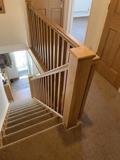 the stairs are made of wood and have handrails