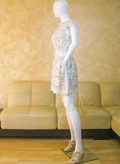 a mannequin dressed in a white lace dress