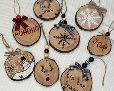 wooden ornaments with snowflakes and words on them