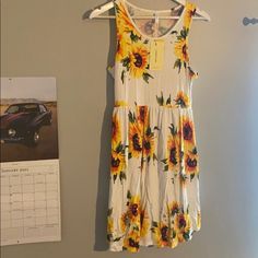 New Sunflower Dress With Tags. Size Medium Summer Garden Party Mini Dress With Flower Shape, Floral Print Mini Dress For Summer, Knee-length Floral Print Sundress For Day Out, Casual Floral Print Midi Dress For Daytime, Casual Floral Print Sundress, Casual Spring Floral Dress, Summer Floral Print Dress For Daytime, Summer Floral Print Midi Dress For Daytime, Casual Floral Print Spring Sundress