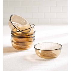 a stack of glass bowls sitting on top of a table