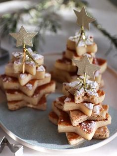 small christmas trees made out of waffles and powdered sugar on a plate