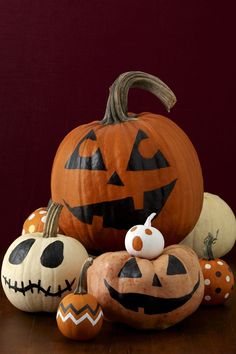 pumpkins and jack - o'- lanterns are arranged on a table