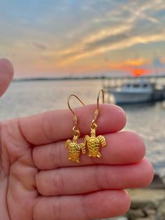 These gold ear wire sea turtle earrings are the absolute cutest accessory! 🐢 The wire on these earrings is 304 Stainless Steel that is gold plated. They measure 21x21x2.5mm🌊 The sea turtle charm is an alloy gold sea turtle pendant measuring 16x12.4x2.2mm☀️ Adjustable Gold Jewelry With Fish Hook, Sea Turtle Jewelry, Turtle Jewelry, Shark Tooth Necklace, Tooth Necklace, Turtle Charm, Turtle Earrings, Face Earrings, Turtle Pendant