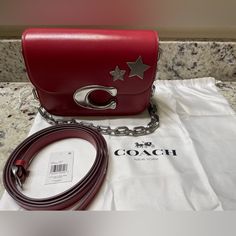 Coach Idol Bag - Cm557 - Red Enamel With Silver Hardware Brand New, Never Used, Nwt, Due Magnetic Closure, During Opening Some Scratches Near The C, Please See Pics Captured. This Is How U Received From Cia H Retail Store. Embellished With Stars Style Number Cm557 Measurements Length: 8.25" Height: 6.25" Width: 3.5" Materials Luxe Refined Calf Leather Leather Lining Strap Detachable Strap With 21.5" Drop For Shoulder Or Crossbody Wear Interchangeable Chain Strap With 9.25" Drop Features Outside Designer Shoulder Bag With Silver-tone Hardware As Gift, Coach Silver Bags For Gifts, Coach Idol Bag, Red Shoulder Bag With Silver-tone Hardware For Evening, Red Coach Bags With Leather Handles, Red Coach Shoulder Bag With Branded Hardware, Coach Red Shoulder Bag With Branded Hardware, Red Coach Shoulder Bag With Removable Pouch, Coach Red Wallet With Removable Pouch