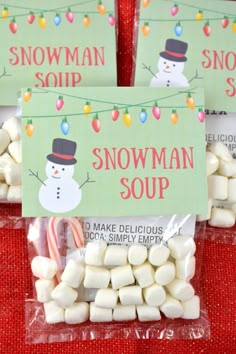 three bags filled with marshmallows sitting on top of a red tablecloth