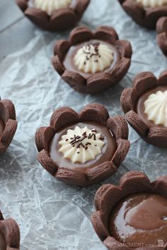 chocolate desserts with white frosting and sprinkles arranged in heart shapes