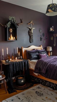 a bed room with a neatly made bed next to a night stand and some candles