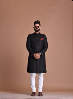 "Important Instructions : We request you to kindly calculate the processing time of your order after the mutual confirmation on Bespoke measurements between us has taken place (either via message , e mail or form) \"Crafted with Passion in India; loved by men across the USA, Canada, Europe\" Material: T R Color: Black Collar type: Mandarin , Sherwani with 7 Buttons Package contents: 1 Achkan + 1 Churidar Pajama Wash Care Instruction : Dry-clean only Achkans also known as Sherwanis were originate Black Achkan For Men, Traditional Black Wear For Wedding And Diwali, Black Traditional Wear For Wedding And Diwali, Formal Black Set With Pallu, Elegant Semi-stitched Black Bandhgala, Traditional Black Kurta For Groom, Traditional Drape Black Kurta For Groom, Black Kurta For Wedding And Diwali, Black Sherwani For Groom On Eid