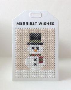 a cross stitch ornament with a snowman on it