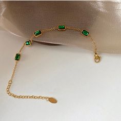 This bracelet is screaming LUXURY! Beautiful Zirconia mixed with rugged lock and chain! . One of a kind design that is perfect for stacking or wearing alone. This piece is made to last, hypoallergenic & waterproof. 316L Stainless Steel 18K Gold Plated, Cubic Zirconia 6 inches long +2 inches ext Green Chain Bracelet Jewelry, Trendy Metal Crystal Bracelet, Crystal Chain Bracelet Gift, Adjustable Dainty Green Chain Bracelet, Trendy Jewelry With Adjustable Rectangular Chain, Trendy Tarnish Resistant Rectangular Bracelets, Trendy Rectangular Jewelry With Adjustable Chain, Trendy Beaded Bracelet With Chain For Gift, Dainty Green Adjustable Chain Bracelet