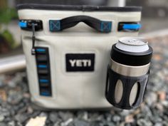 a yeti cooler and cup sitting on the ground