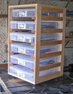 several plastic containers stacked on top of each other in a storage unit with wooden shelves