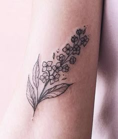 a flower tattoo on the arm is shown in black and grey colors, with an image of