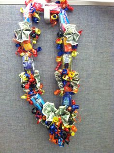 a necklace made out of gummy bears and candy bars is hanging on the wall