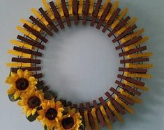 a sunflower wreath made out of wooden slats