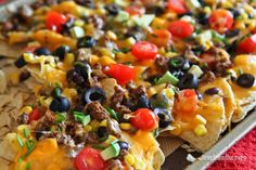 a tray filled with nachos covered in cheese and toppings