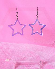 iridescent acrylic choice of sterling silver .925 or surgical stainless steel approximately 2.5" long in full length (from top of metal to bottom of acrylic), 1.5" wide made from an iridescent acrylic, these hollow star earrings bring a groovy retro 1970s or 1980s vibe and lovely rainbows! this product is made to order, colors may appear slightly different care: the acrylic and metal can be cleaned with a light cleaner Rainbow Star-shaped Jewelry With Star Charm, Trendy Purple Star-shaped Jewelry, Trendy Purple Star Shaped Jewelry, Handmade Rainbow Star Jewelry, Trendy Purple Star Jewelry, Star Dangle Earrings, Iridescent Acrylic, Groovy Retro, Pastel Rainbow