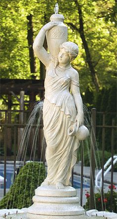 a fountain with a statue holding a water jug