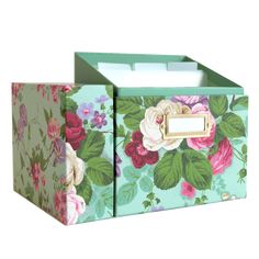 two boxes with flowers painted on them, one is green and the other is pink