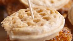 fried chicken and waffle sandwiches with toothpicks on them are ready to be eaten