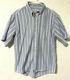 Brand: Mercedes by Enro Color: Blue/White Description: Mens short sleeve button up polo, striped Material Type: 60% combed cotton, 40% polyester Size: 16 1/2 Condition: Gently pre-owned in great condition.  Inventory Number: 20EE Fitted Polo Shirt With Buttons For Spring, Spring Fitted Button-up Polo Shirt, Striped Short Sleeve Polo Shirt For Summer, Fitted Cotton T-shirt With Button Closure, Light Blue Fitted Polo Shirt With Polo Collar, Fitted Light Blue Polo Shirt With Polo Collar, Summer Polo Shirt With Collar And Pockets, Fitted Light Blue Polo Shirt, Spring Short Sleeve Polo Shirt