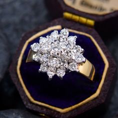 an antique diamond cluster ring in a velvet box