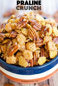 a bowl full of pecans sitting on top of a wooden table