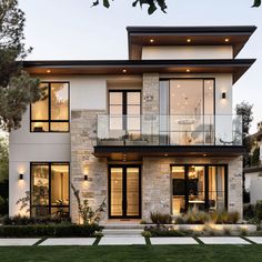 a modern house with large windows and lots of grass