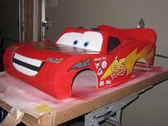 a cake shaped like a race car sitting on top of a table