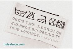 an embroidered label on a white shirt that says, one's life shrinks or expends according to your courage