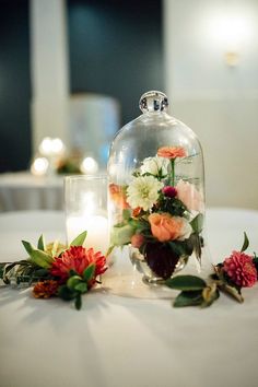 flowers under a glass dome on a table