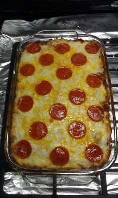 pepperoni and cheese pizza sitting on top of an oven