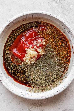 a white bowl filled with spices and seasoning