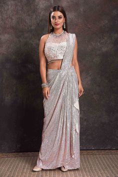 Buy beautiful silver sequin georgette pre-draped saree online in USA with designer blouse. Look your ethnic best on festive occasions with latest designer sarees, pure silk sarees, Kanchipuram silk sarees, designer dresses, Anarkali suits, gown, embroidered sarees from Pure Elegance Indian fashion store in USA.-full view Silver Georgette Pre-draped Saree For Wedding, Elegant Silver Pre-draped Saree For Evening, Silver Pre-draped Saree With Mirror Work, Silver Traditional Drape Choli For Party, Fitted Silver Pre-draped Saree For Designer Wear, Silver Party Choli With Traditional Drape, Silver Choli For Evening And Festive Occasions, Glamorous Floor-length Georgette Pre-draped Saree, Festive Silver Choli For Evening