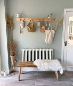 a white bench sitting in front of a wall mounted radiator