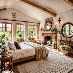 a bedroom with a bed, mirror and fireplace in the corner next to two windows