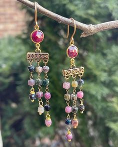 These earrings are colorful with beautiful cube shape tourmalines that coated for some shimmer. They are truly a gorgeous arrangement of colors. The bezel connectors are ruby. All metal components are gold filled, gold plated, and non-tarnish gold brass. These earrings are 3.25"long. Cube Shape, Peridot Earrings, Ruby Beads, New Earrings, Aqua Chalcedony, Strawberry Quartz, Quartz Earrings, Gold Brass, Morganite