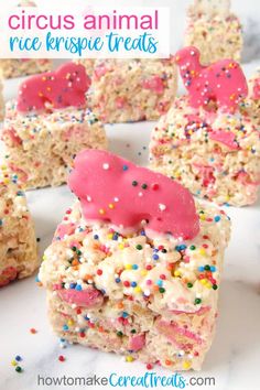 some rice krispy treats with pink frosting and sprinkles on top