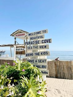 a sign that says welcome to paradise cove on the beach