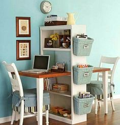 a room with a desk, chair and laptop on the table in front of it