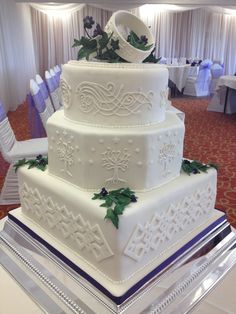 a large white wedding cake sitting on top of a table