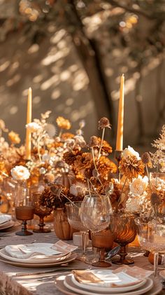 the table is set with flowers and candles for an elegant dinner party or special event