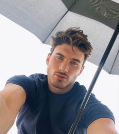 a man holding an umbrella in his hand