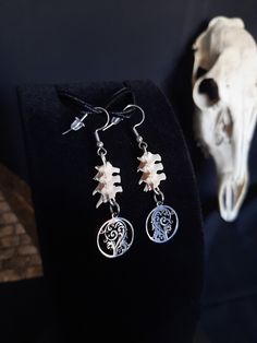 Here is a Nice Pair of Forest Witch Earrings, They Were Made with some real Rattlesnake Vertebrae. These earrings are Stainless Steel. They Are Around 2 Inches long. All Items Ship Within 1-3 Days via USPS Ground Advantage Service. Shipping on these will be 5.50 (USA Only) All additional items are FREE! International Shipping Will Be 22.00 + 2.00 For each Additional Item. Canada 20.00 + 2.00 For each Additional Item. International Shipping May Take 2 - 6 Weeks to Deliver I DO NOT Carry Human Bones or Any Sort of Illegal Items. And As Etsy Sellers, We Are Not Allowed to Sell Domesticated Dog or Cat Bones of Any Sort. All The Bones Here are Legal to Buy, Sell, And Own in the United States. Cat Bones, Viking Earrings, Forest Witch, Earrings Gothic, Human Bones, Witch Earrings, Bone Earrings, House Aesthetic, Gothic Earrings