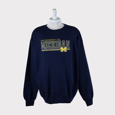 Embroidered Vintage 90s Michigan Wolverines (University of Michigan) Football/Baseball/Basketball/Hockey NCAA Sweatshirt 💯 SATISFACTION AND AUTHENTICITY ⭐ MEASUREMENTS (when laid flat) Size on Tag: XL (fit 2XL) Length: 80cm or 31.5 inches Armpit to armpit: 67cm or 26.5 inches ⭐ CONDITION 9/10 (Very good) Details: No holes Material: Cotton Color: Dark Blue Navy Brand: Majestic 🔷 Please give us your phone no. together with address after you purchased. 🔷Please keep in mind that our items are vin University Michigan, Wolverine Shirt, Michigan University, Football Sweater, West Virginia University, Michigan Football, West Virginia Mountaineer, University Of Virginia, University Of Michigan